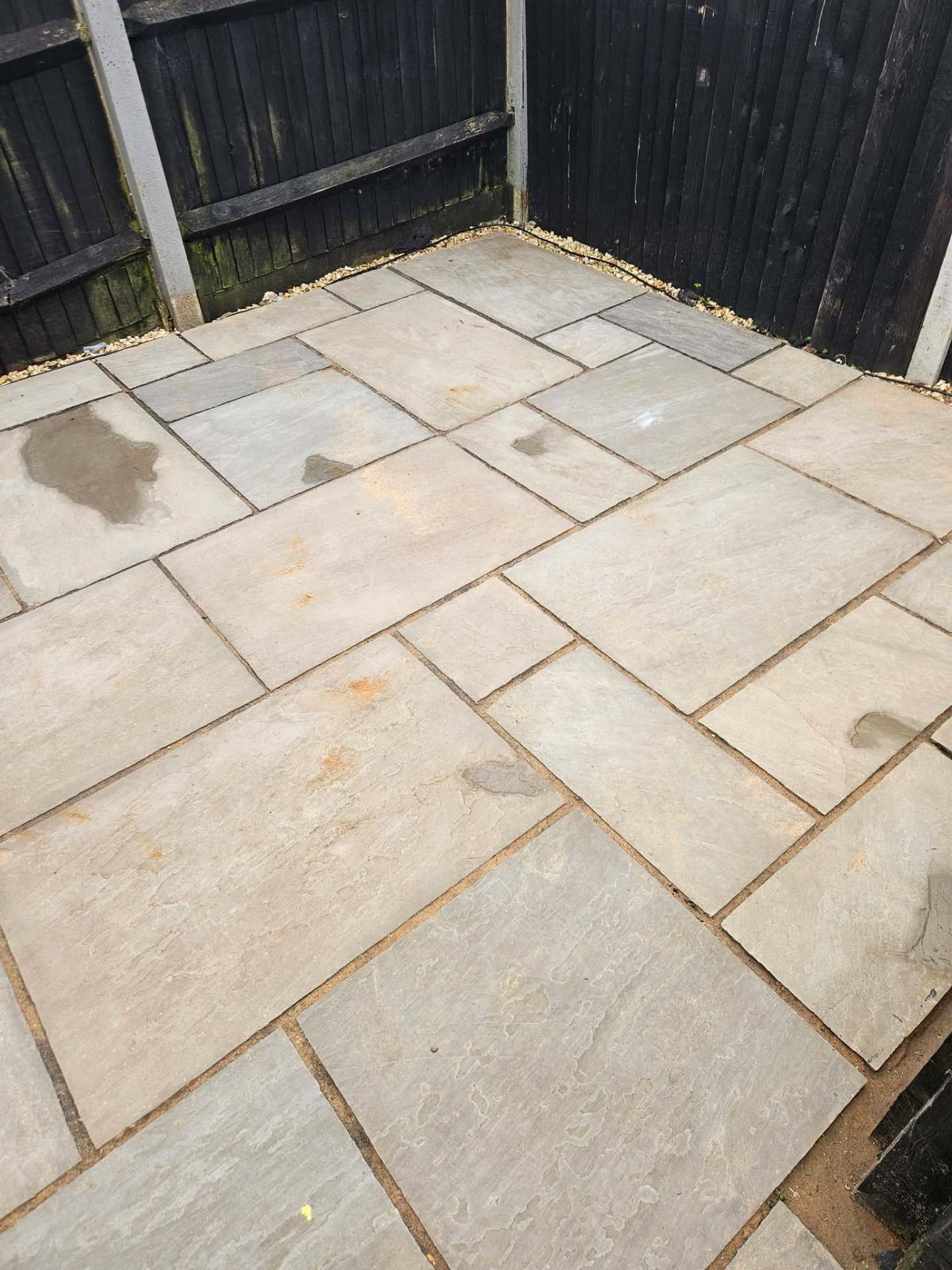 Same patio revitalised to a rich, even grey after softwash treatment and jet wash