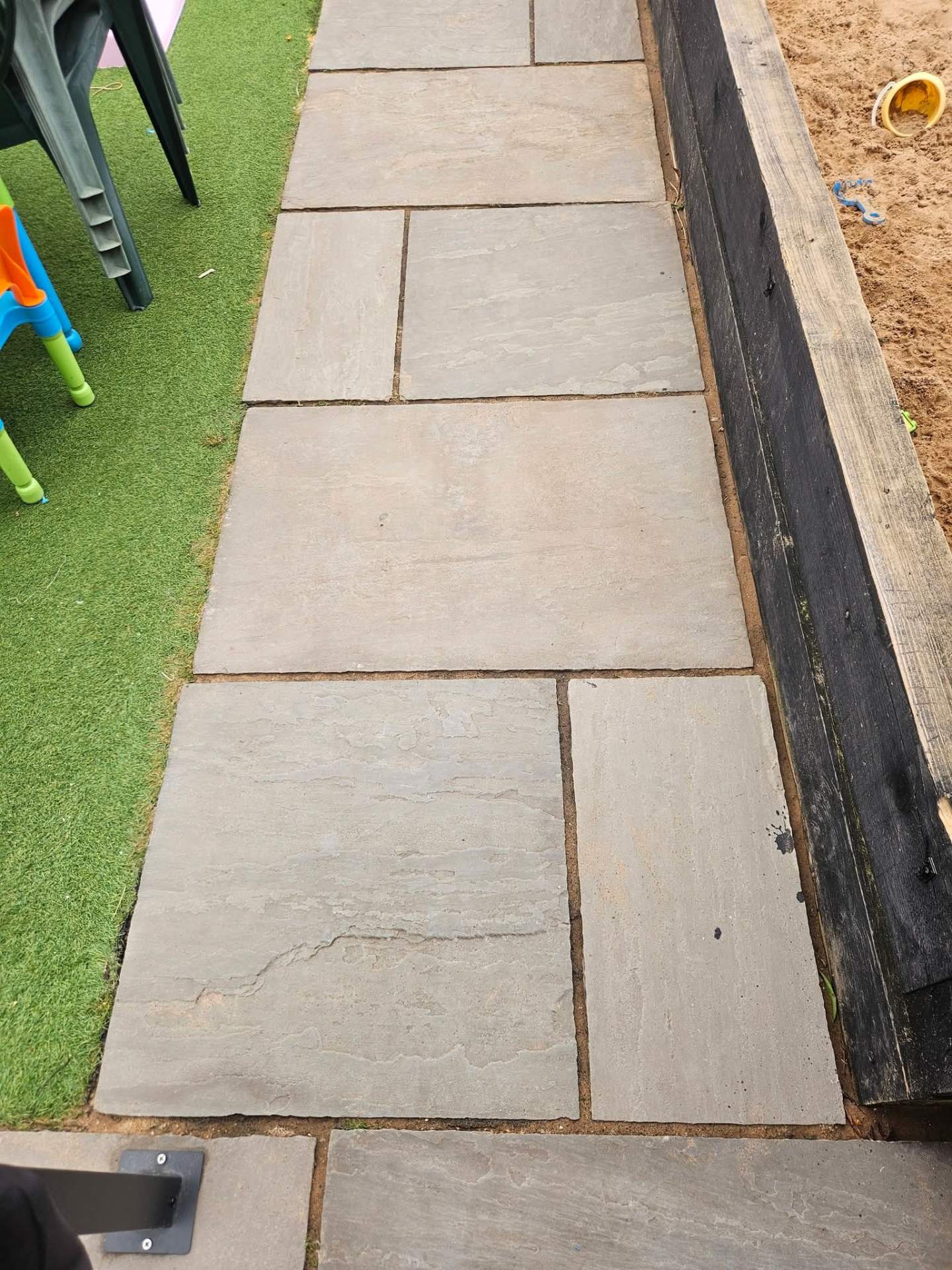 Same Indian sandstone patio restored to clean, uniform grey after controlled jet washing