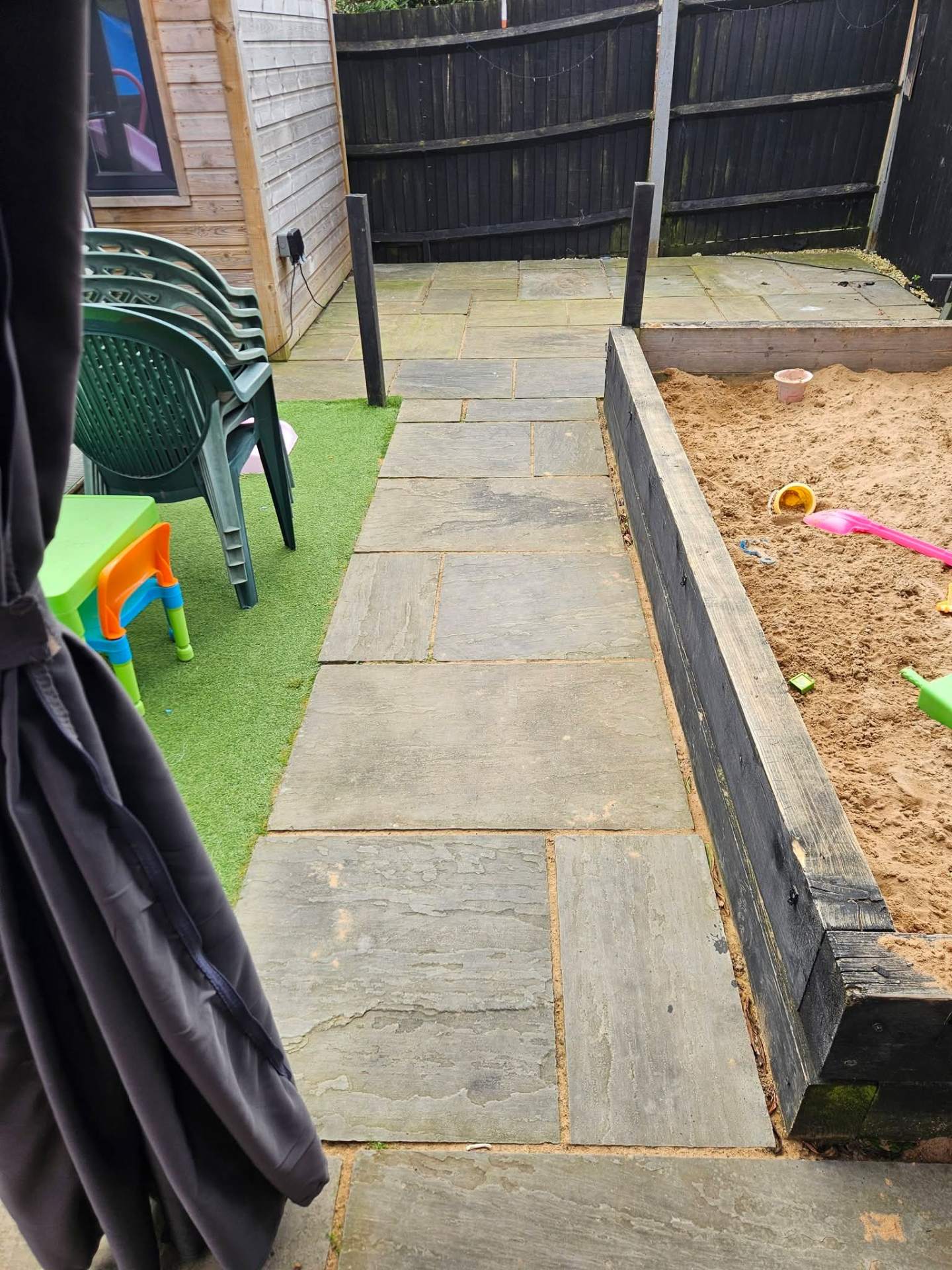 Algae-stained Indian sandstone patio and pathway before jet washing — South Hampshire