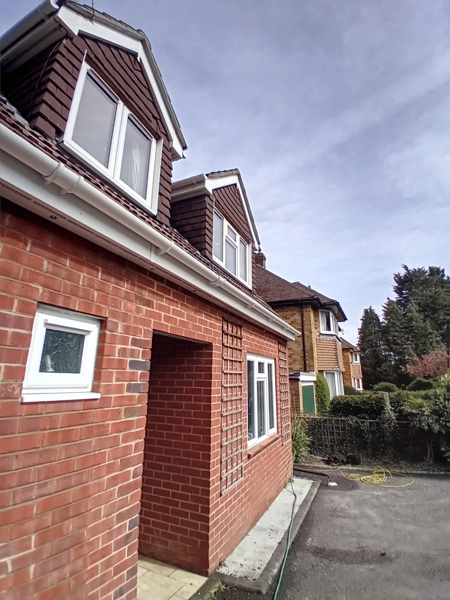 Dormer fascias, soffits and guttering cleaned bright white along the side elevation