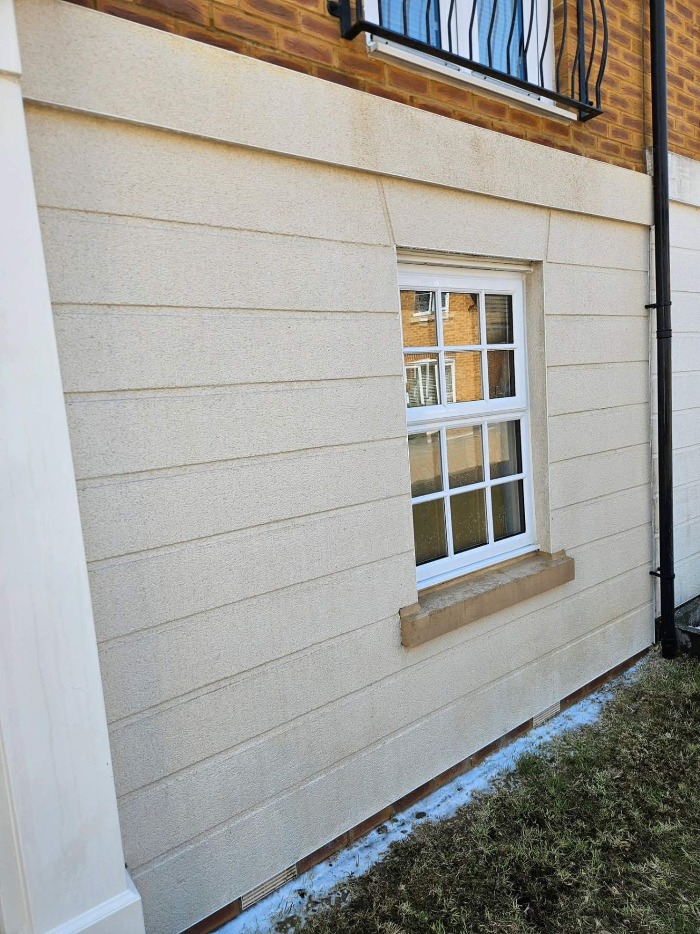 Softwashed render wall restored to a clean, uniform finish — South Hampshire home
